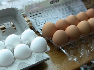 White and golden brown eggs side by side